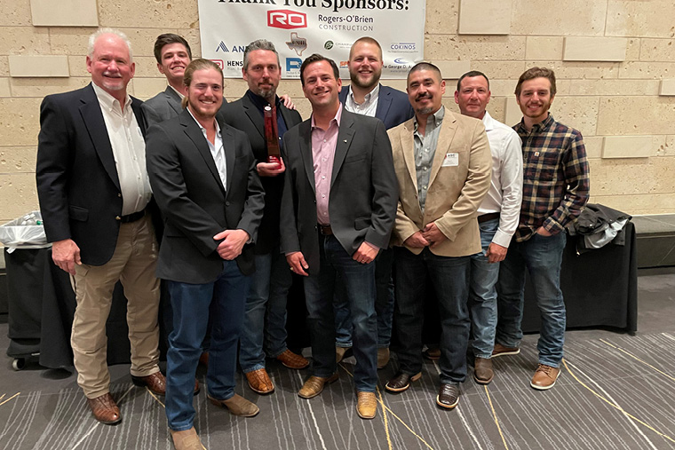 Industry awards event · team group photo with sponsor wall